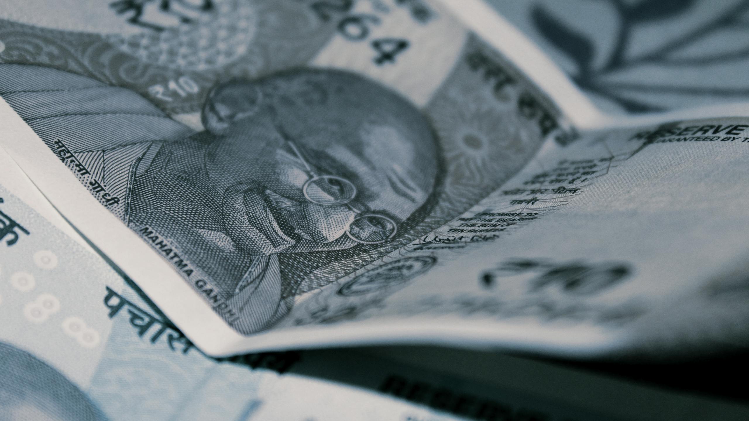 Detailed close-up of Indian Rupee banknotes with iconic Gandhi portrait, emphasizing economy and currency themes.