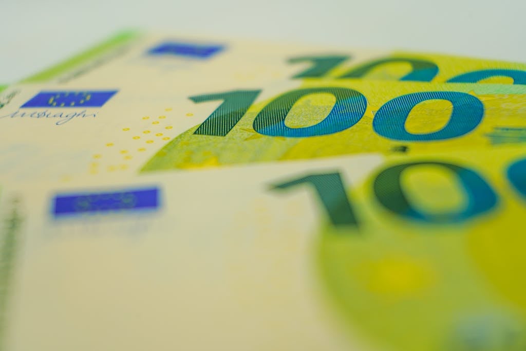 Euro banknotes in close-up with focus on 100 denomination. Perfect for financial themes.