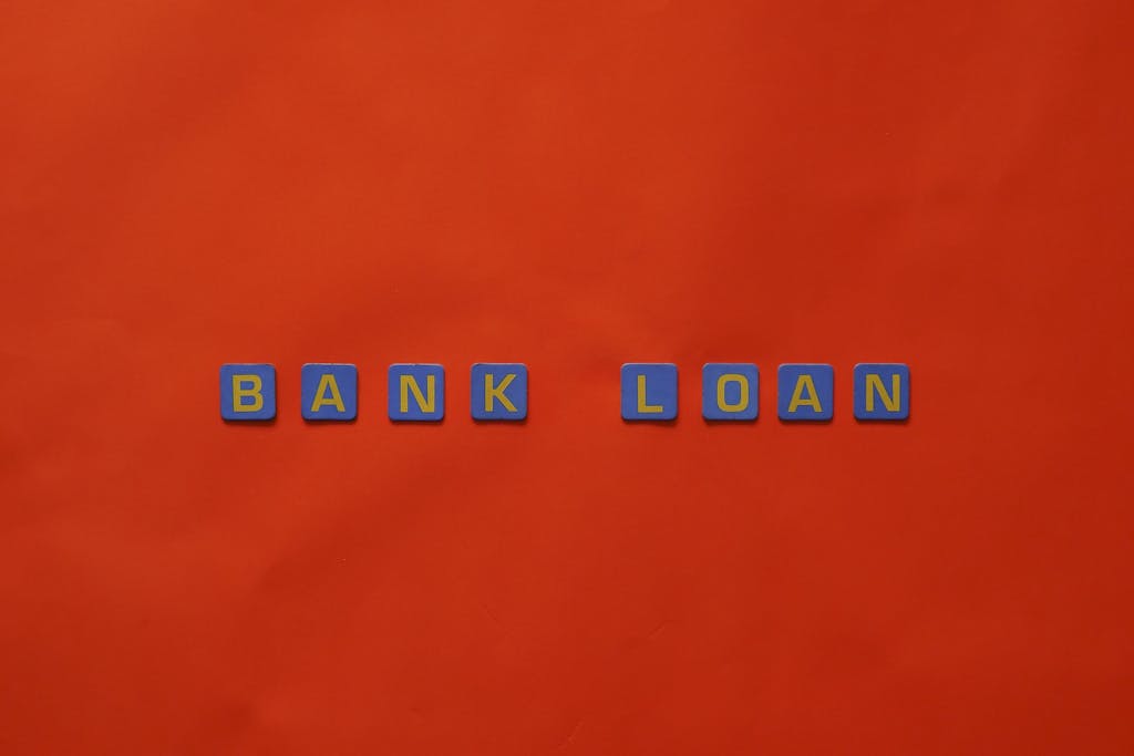 Letters forming 'Bank Loan' on a vibrant red surface, ideal for finance themes.